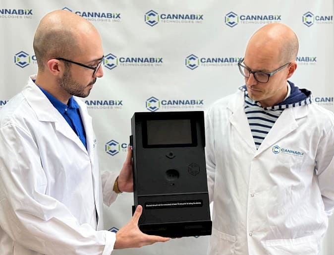 Two team members from Cannabix Technologies, including Babak Ghorbani, examining the BreathLogix Industrial Series alcohol screening device